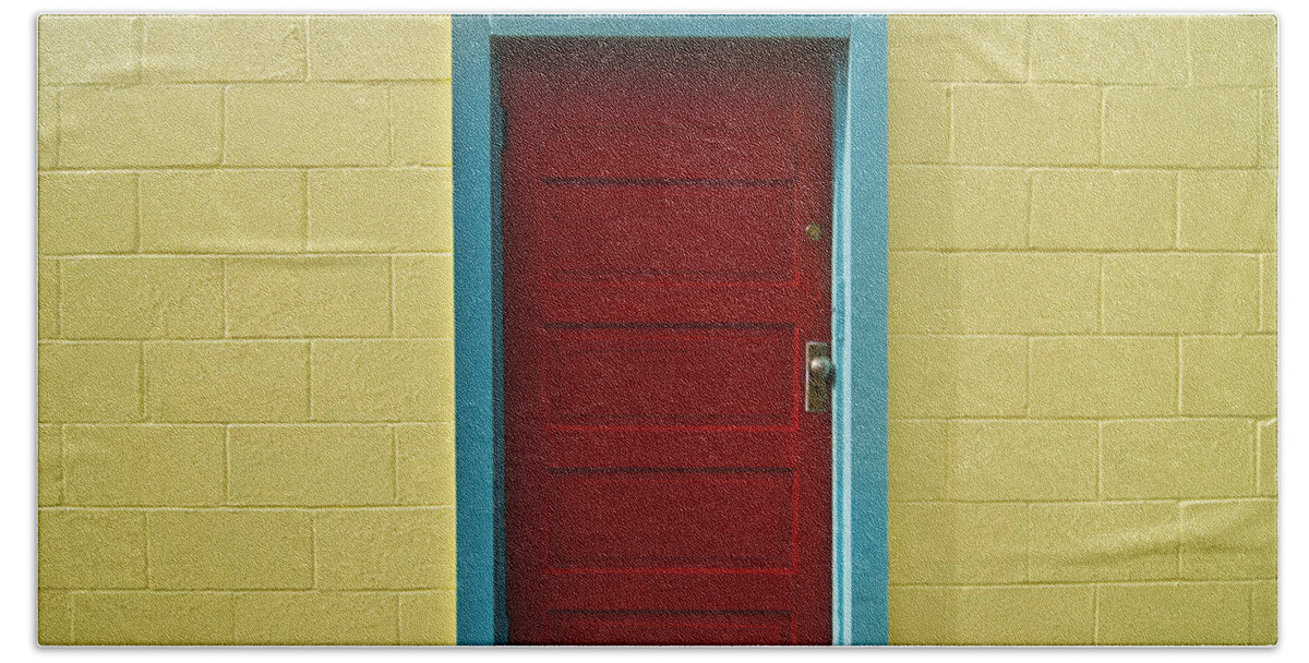 Aqua Bath Towel featuring the photograph Yellow Wall and Red Door by Ray Laskowitz