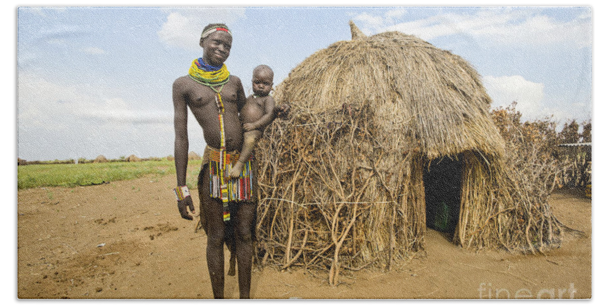 Nyangatom Bath Towel featuring the photograph Nyangatom woman with baby in arms #1 by Eyal Bartov