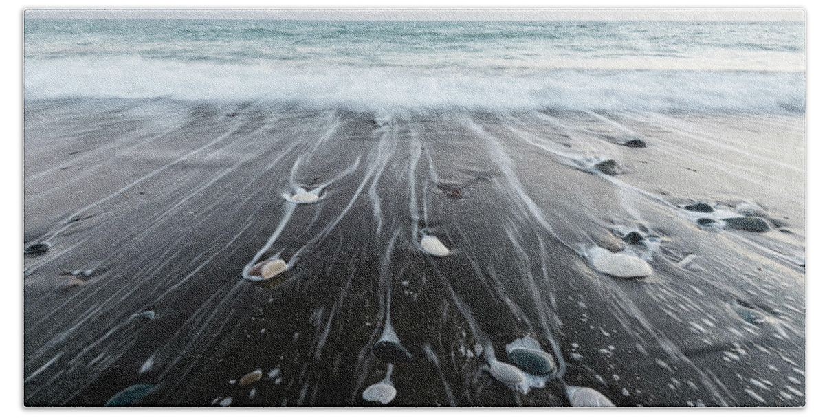 Seascape Bath Towel featuring the photograph Pebbles in the beach and flowing sea water by Michalakis Ppalis