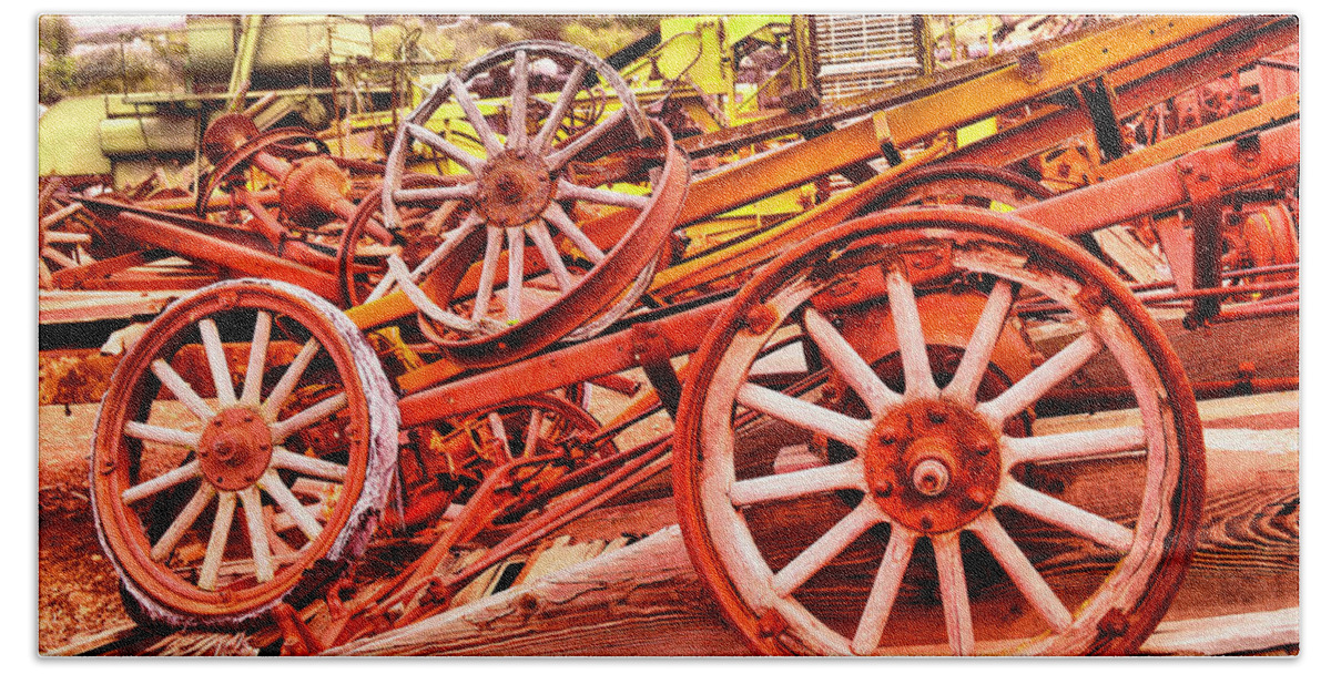 Wheels Bath Towel featuring the photograph A pile of three old wheels by Jeff Swan