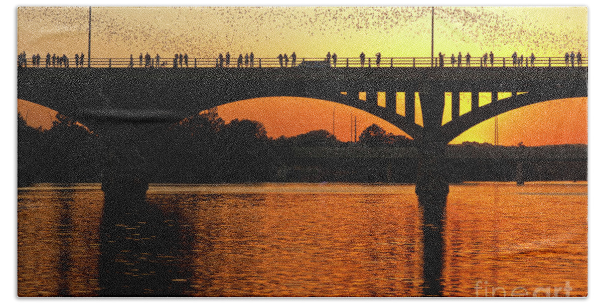 Mexican Free-tail Bats Hand Towel featuring the photograph A vivid sunset surrounds the Mexican free-tailed bats as they fly out of Congress Avenue Bridge by Dan Herron
