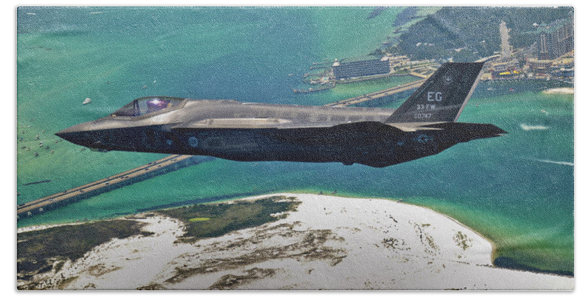 Stealth Bath Sheet featuring the photograph An F-35 Lightning II Flies Over Destin by Stocktrek Images