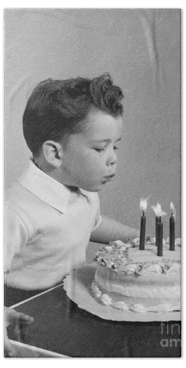 1950s Bath Towel featuring the photograph Boy Blowing Out Candles On Cake, C.1950s by H. Armstrong Roberts/ClassicStock