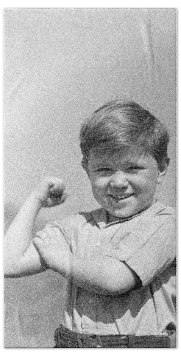 1930s Bath Towel featuring the photograph Boy Flexing Muscles, C.1930s by H. Armstrong Roberts/ClassicStock