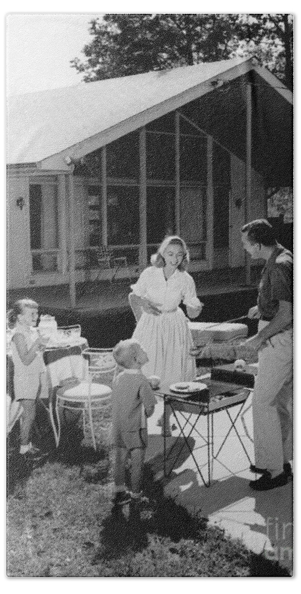 1950s Bath Towel featuring the photograph Family Grilling In Backyard, C.1950s by H. Armstrong Roberts/ClassicStock