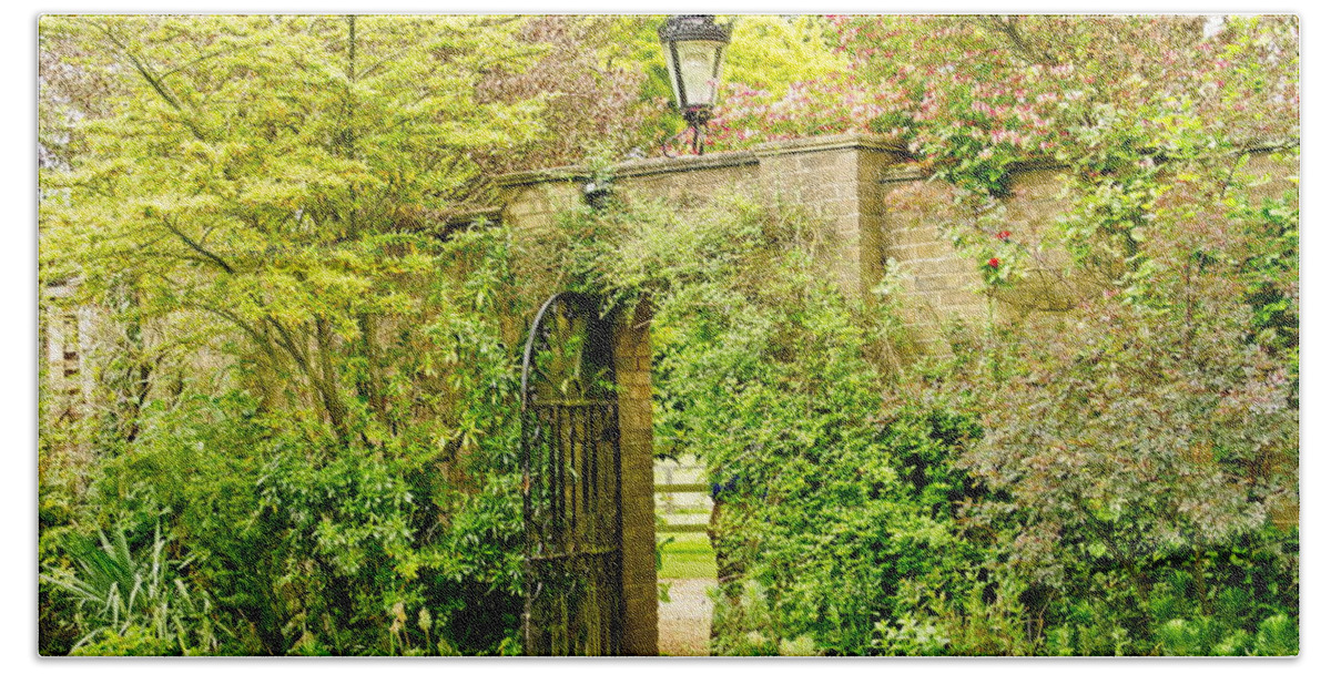 Garden Wall Bath Towel featuring the photograph Garden Wall With Iron Gate And Lantern. by Elena Perelman