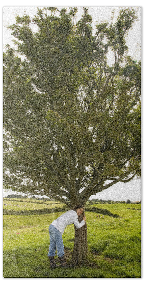 Green Bath Towel featuring the photograph Hugging the fairy tree in Ireland by Ian Middleton