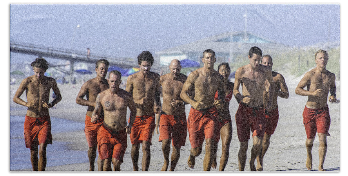  Life Guard Hand Towel featuring the photograph Kure Beach Life guards on the run by WAZgriffin Digital