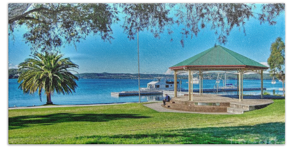 Waterfront Park Hand Towel featuring the photograph Lush green grassy waterfront park with a quaint little old Band by Geoff Childs