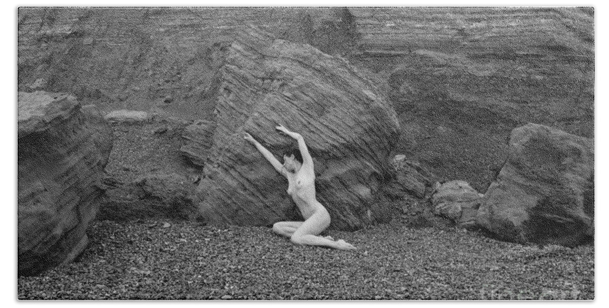 Woman Hand Towel featuring the photograph Nude woman pulling shape by rocks by Clayton Bastiani