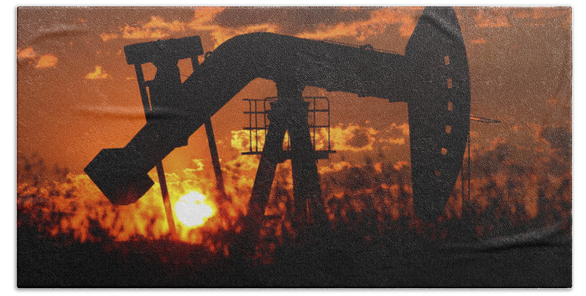 Oil Rig Bath Towel featuring the photograph Oil rig pump jack silhouetted by setting sun by Mark Duffy