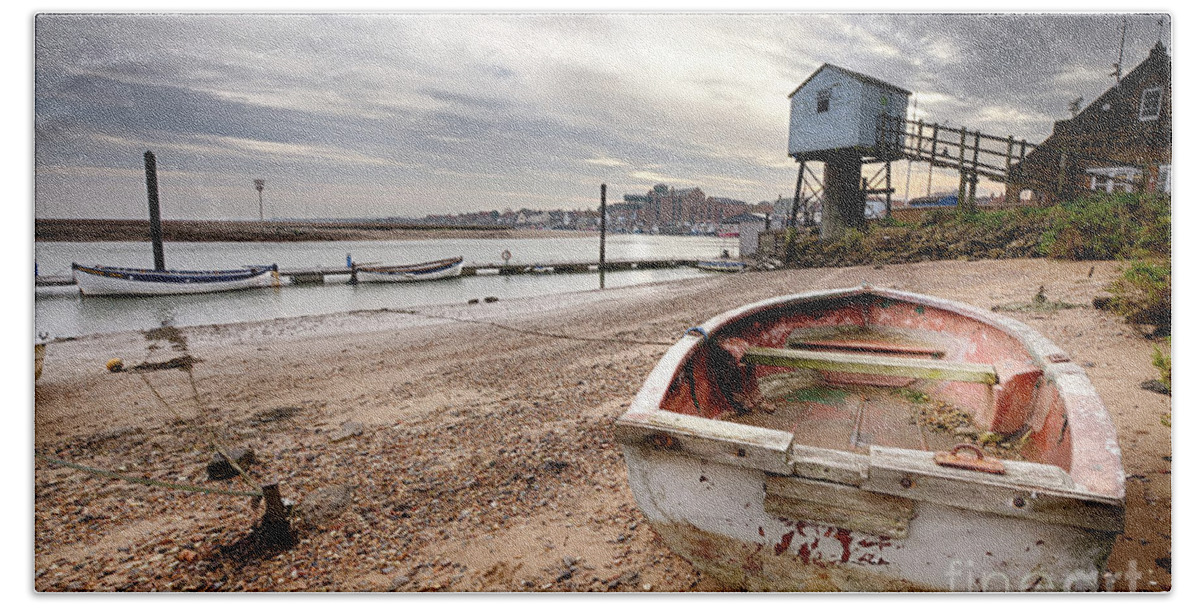 Norfolk Bath Towel featuring the photograph Old rowing boat and lookout tower on beach by Simon Bratt
