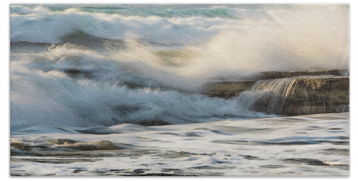 Sea Waves Bath Towel featuring the photograph Rocky seashore, wavy ocean and wind waves crashing on the rocks by Michalakis Ppalis