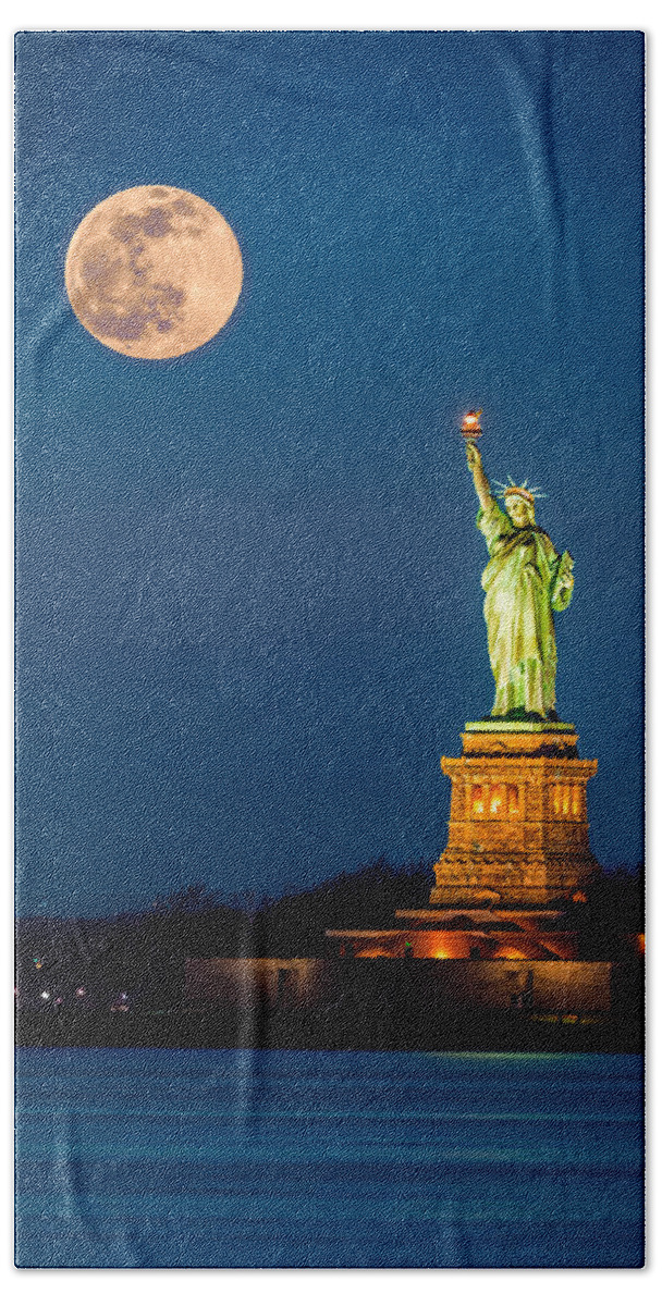America Hand Towel featuring the photograph Statue of Liberty and a rising supermoon in New York City by Mihai Andritoiu