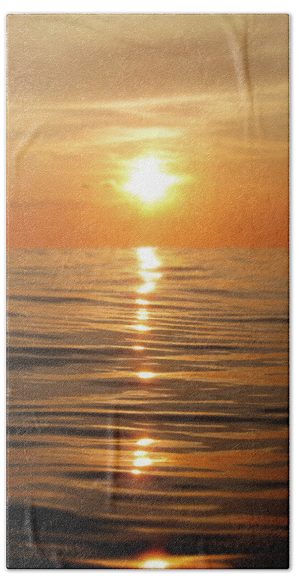 Golden Hand Towel featuring the photograph Sun setting over calm waters by Nicklas Gustafsson