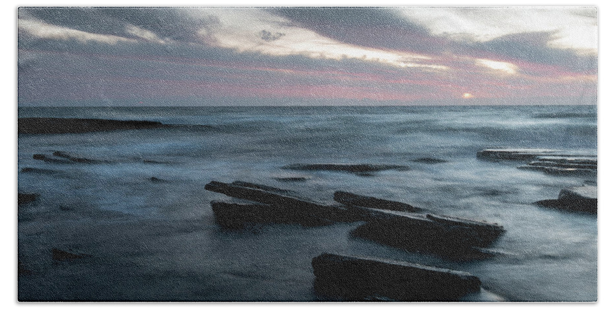 Seascape Bath Towel featuring the photograph Sunset on a rocky beach by Michalakis Ppalis