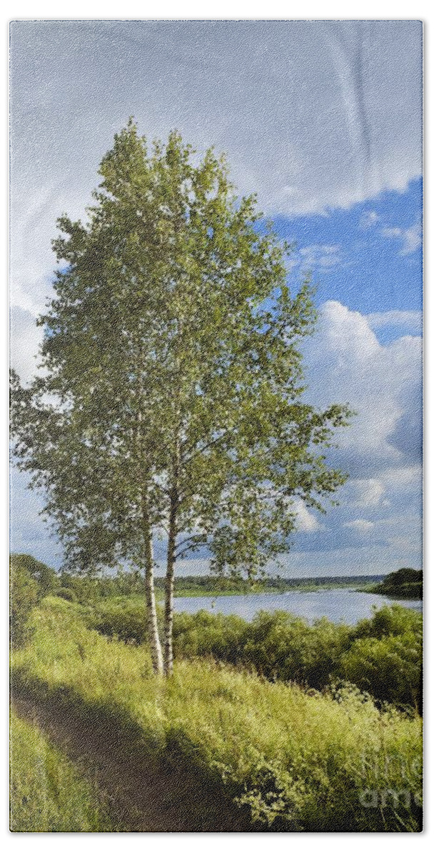 Air Hand Towel featuring the photograph Tree Under Blue Sky On The River Coast by Vadzim Kandratsenkau