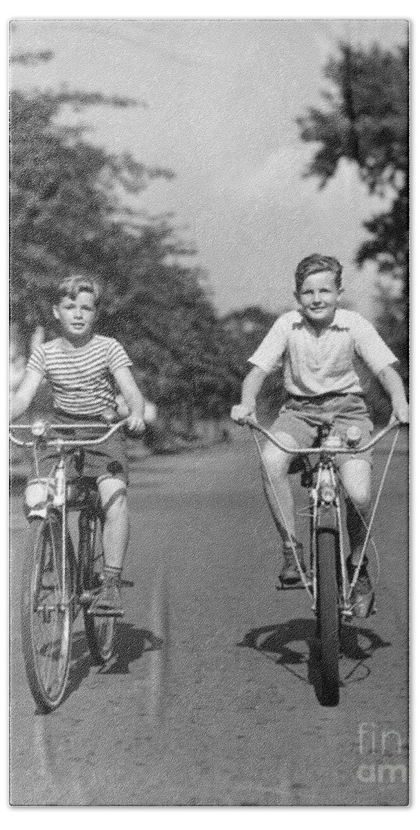 1930s Bath Towel featuring the photograph Two Boys Riding Bikes, C.1930-40s by H Armstrong Roberts ClassicStock