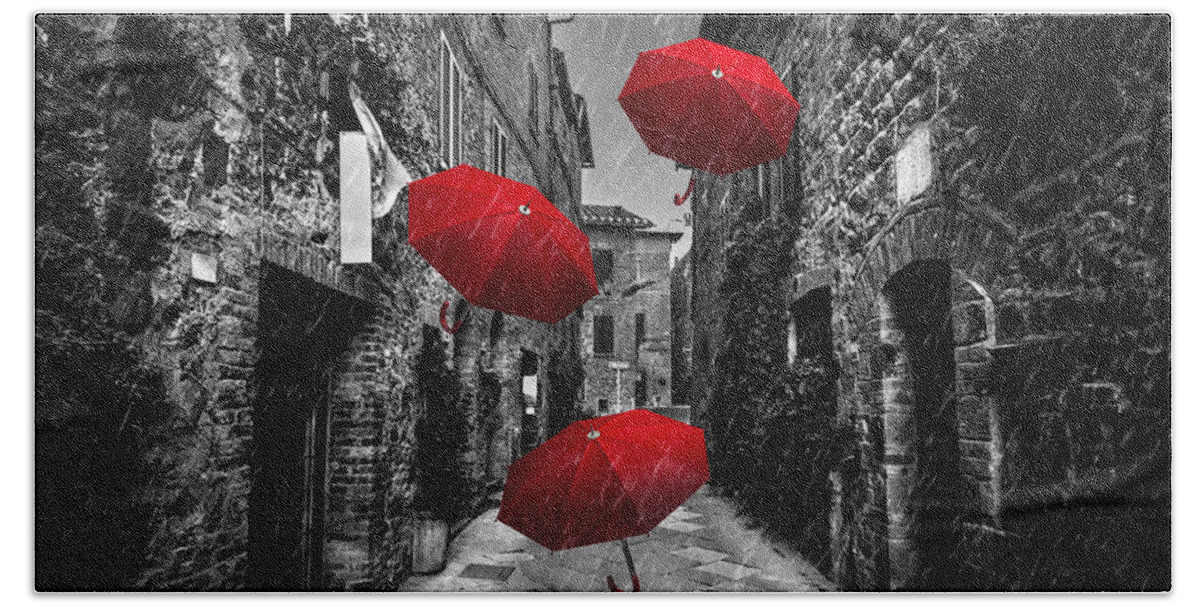 Italian Bath Towel featuring the photograph Umrbellas flying with wind and rain on dark street in an old Italian town in Tuscany, Italy by Michal Bednarek