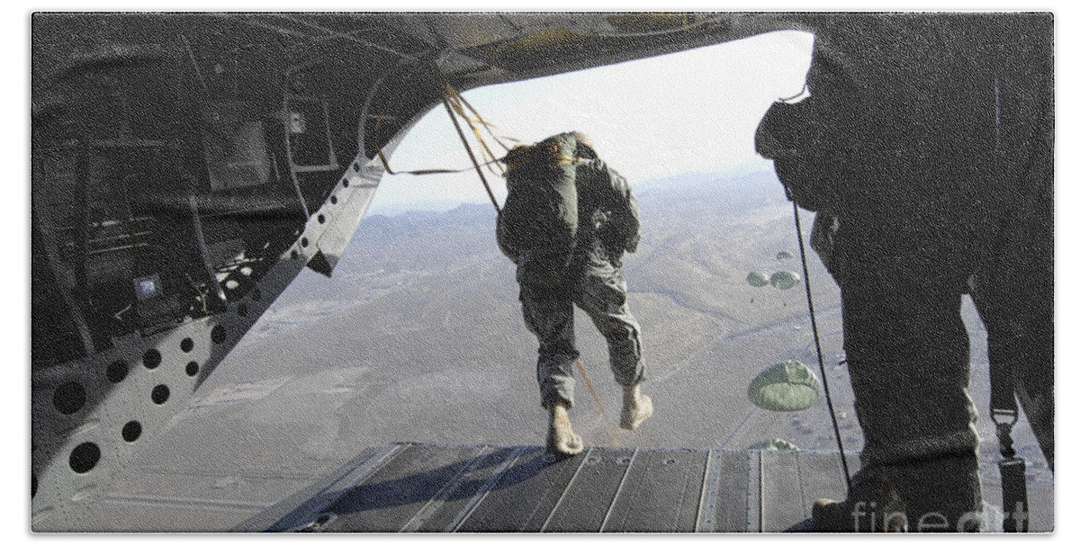 Ch-47 Chinook Hand Towel featuring the photograph U.s. Airmen Jump From A Ch-47 Chinook by Stocktrek Images