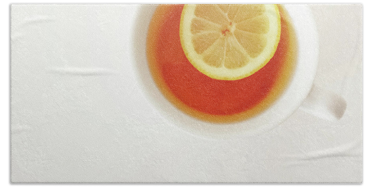 Tea Hand Towel featuring the photograph White cup of tea with lemon by GoodMood Art