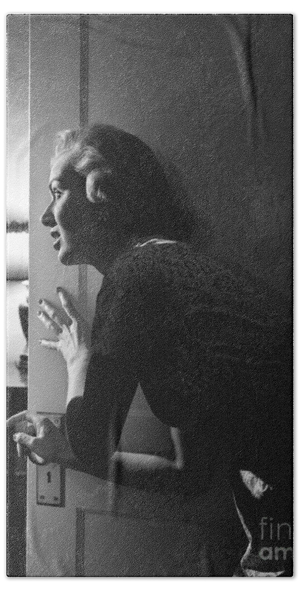 1950s Bath Towel featuring the photograph Woman Peeking Through Door, C.1950s by Debrocke/ClassicStock