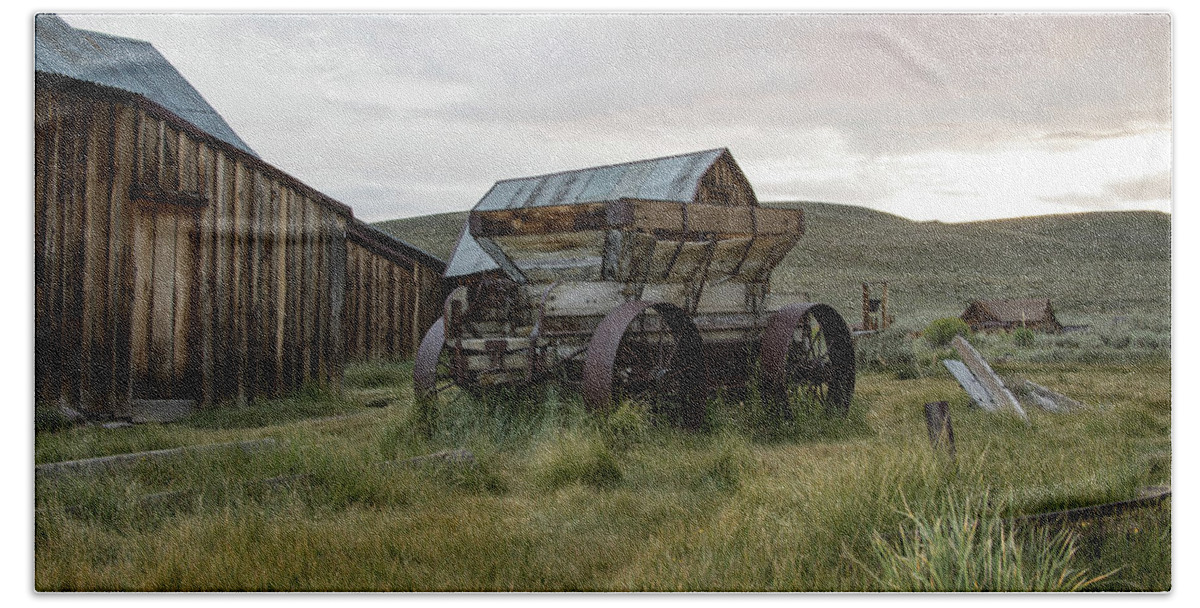Abandoned Bath Towel featuring the photograph Wooden wagon in field, Bodie, California by Karen Foley