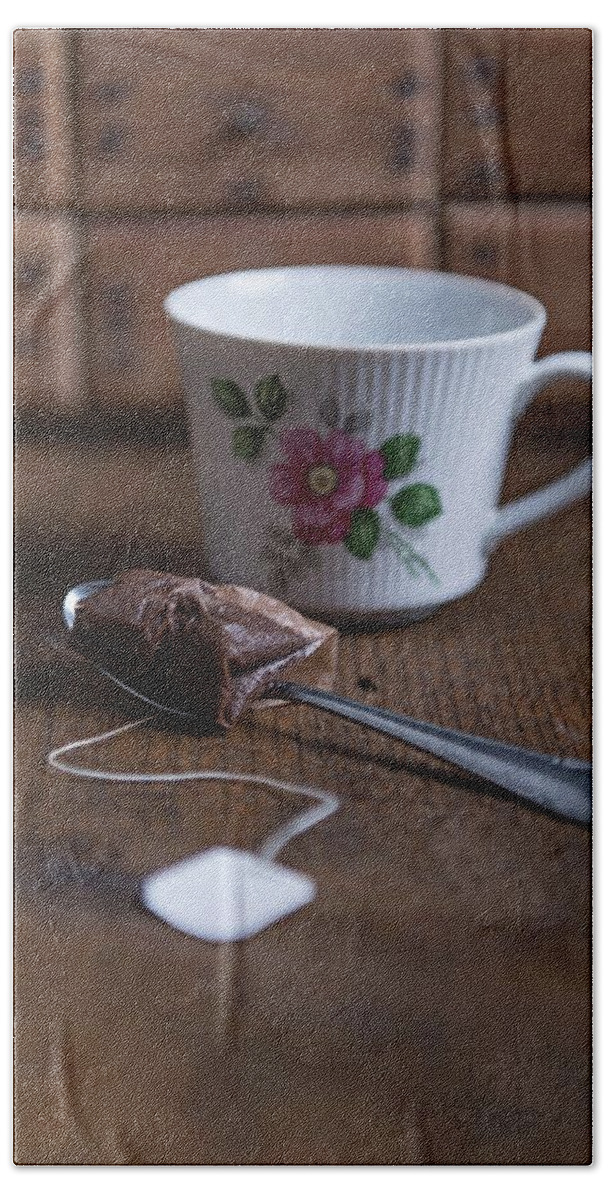 Ip_11396541 Hand Towel featuring the photograph A Used Tea Bag On A Spoon And A Tea Cup With An Eat Frisian Tea Rose Pattern by Angelika Grossmann