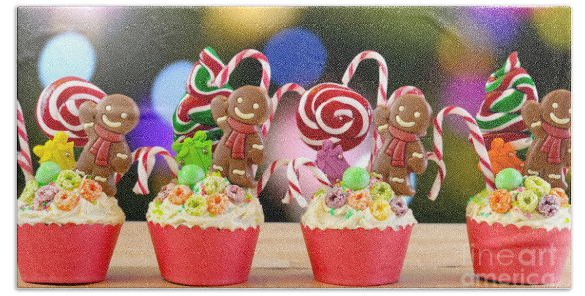 Christmas Hand Towel featuring the photograph Candyland festive Christmas cupcakes. by Milleflore Images