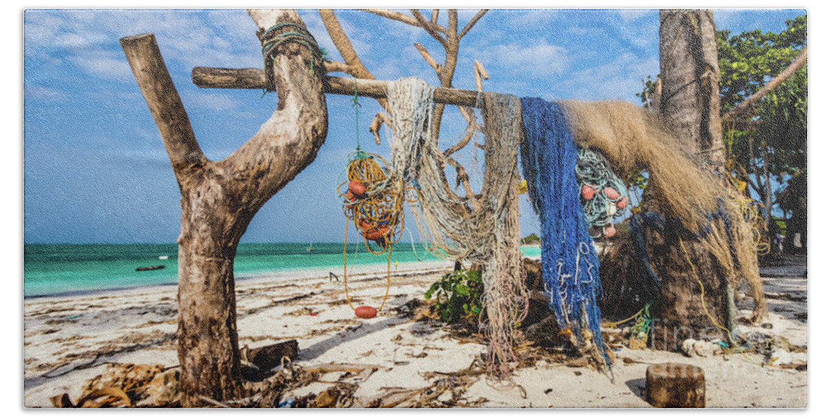 Beach Hand Towel featuring the photograph Fishing nets drying on the beach by Lyl Dil Creations