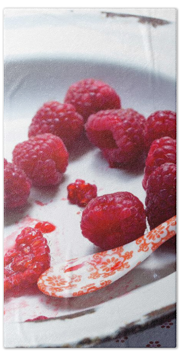 Ip_11987036 Hand Towel featuring the photograph Fresh Raspberries On An Enamel Plate With A Porcelain Spoon by Charlotte Von Elm