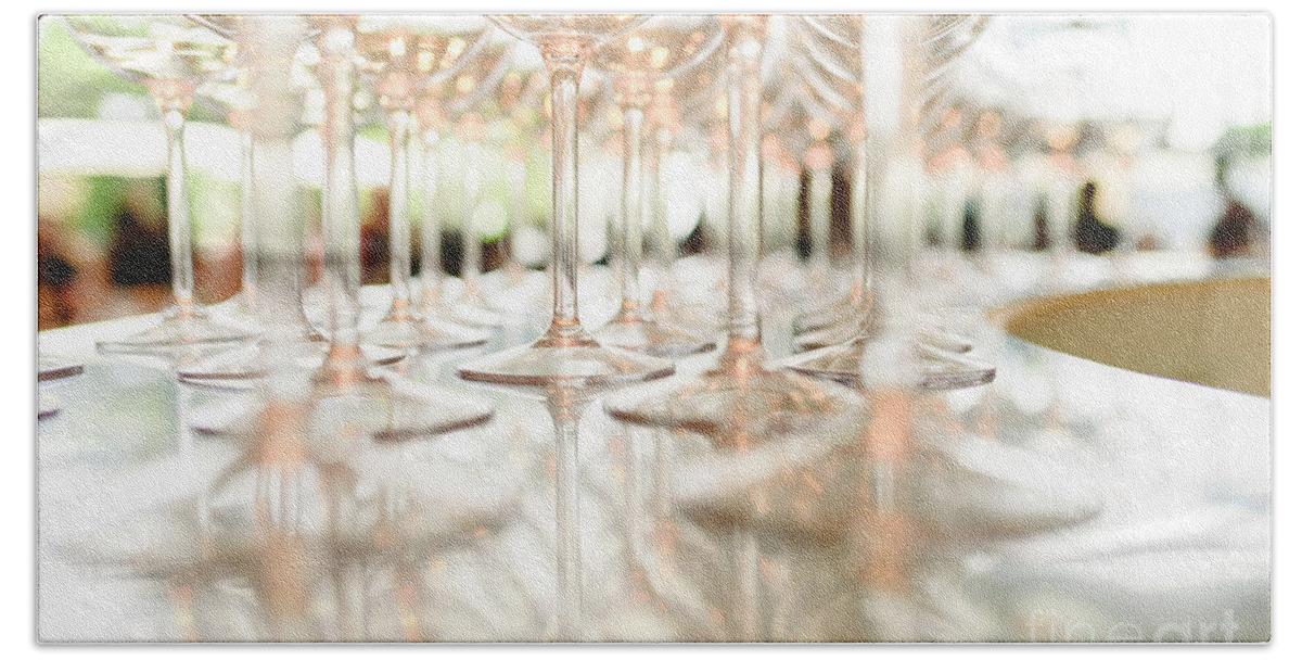 Abstract Hand Towel featuring the photograph Group of empty transparent glasses ready for a party in a bar. by Joaquin Corbalan