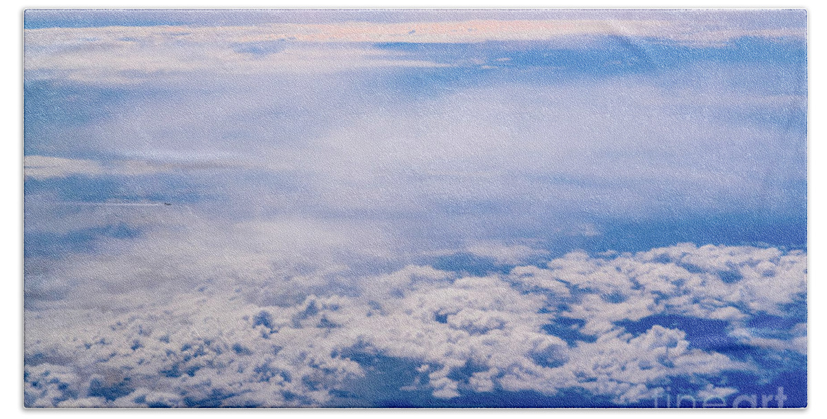 Across Hand Towel featuring the photograph Intense blue sky with white clouds and plane crossing it, seen from above in another plane. by Joaquin Corbalan