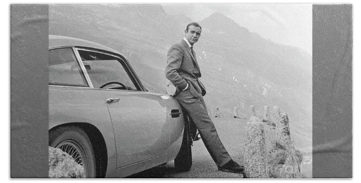 James Bond Hand Towel featuring the photograph James Bond Coolly Leaning on His Aston Martin by Doc Braham