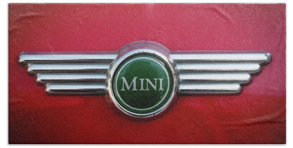 Mini Bath Towel featuring the photograph Mini Cooper car logo on red surface by Michalakis Ppalis