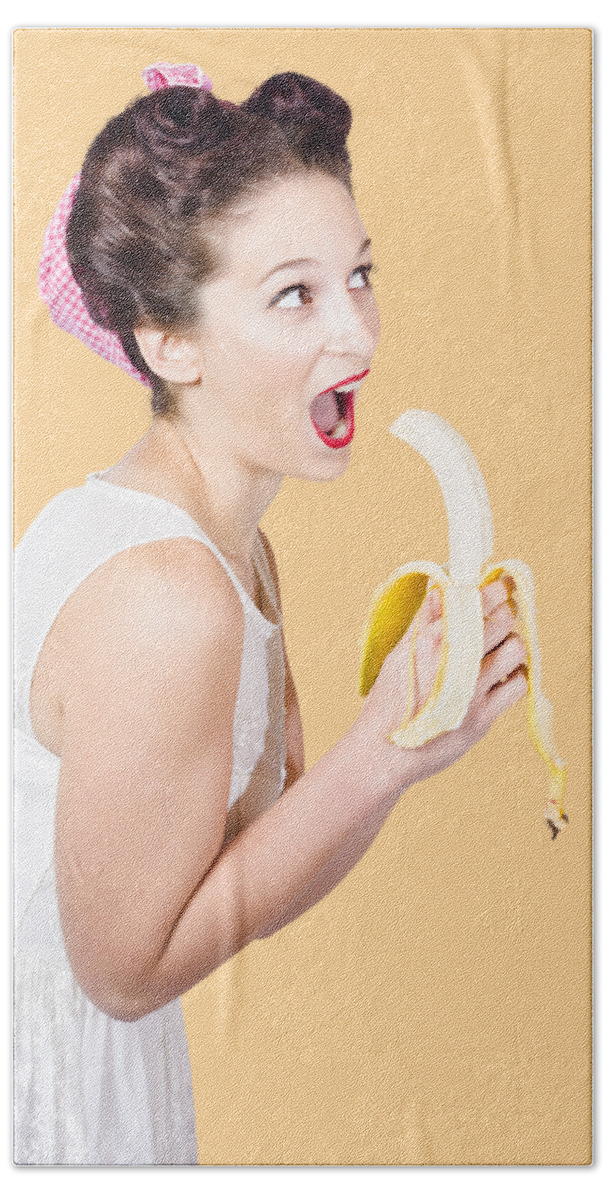 Fruit Bath Towel featuring the photograph Pin-up woman eating fruit on studio background by Jorgo Photography