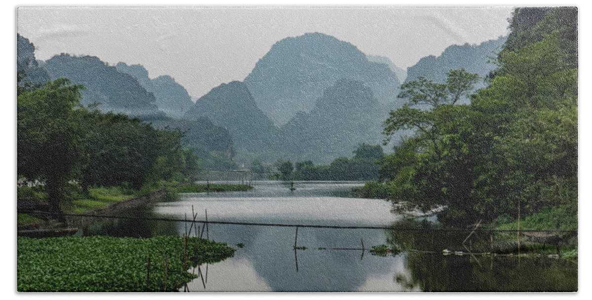 Landscape Hand Towel featuring the photograph river and limestone mountains in Vietnam by Ann Moore