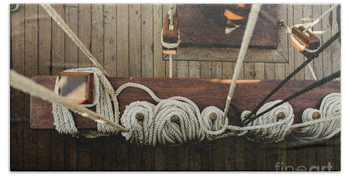 Abstract Hand Towel featuring the photograph Ropes to hold the sails of an old sailboat rolled. by Joaquin Corbalan