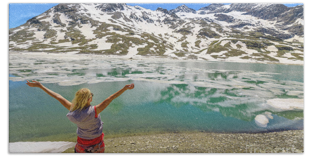 Switzerland Bath Towel featuring the photograph woman on Swiss White lake trekking #1 by Benny Marty