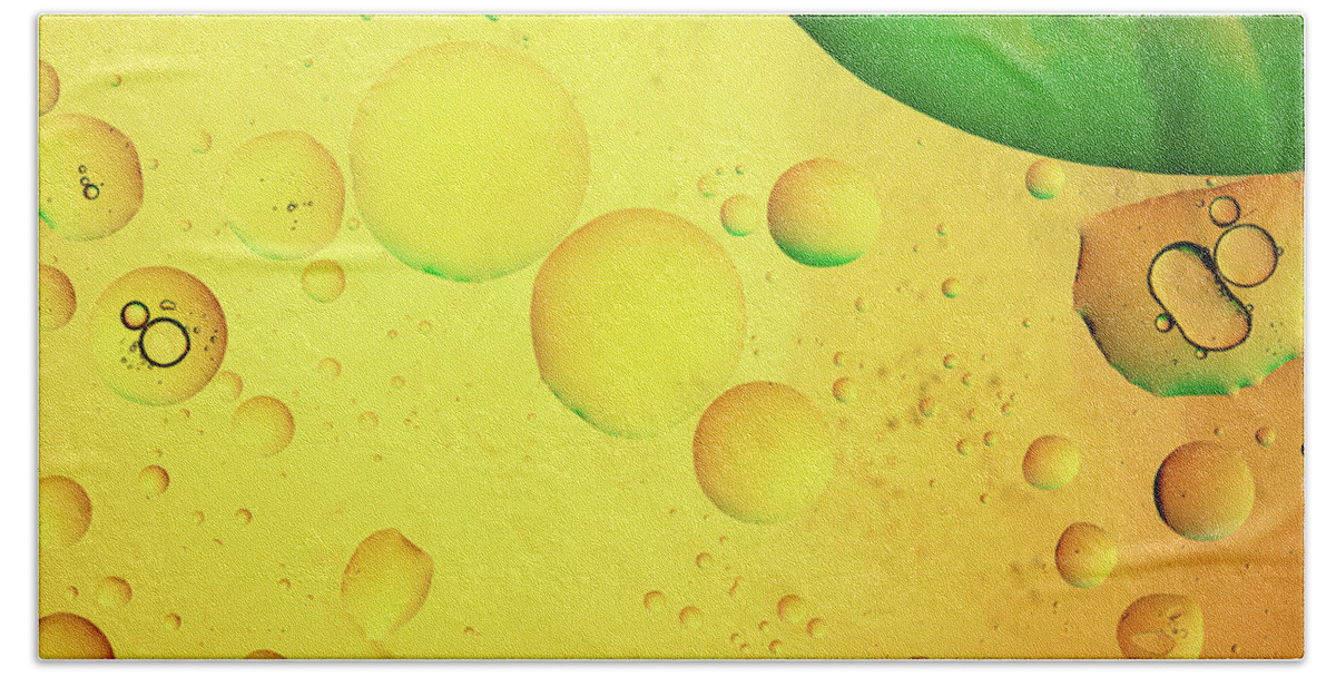 Fluid Bath Towel featuring the photograph Abstract, image of oil, water and soap with colourful background by Michalakis Ppalis