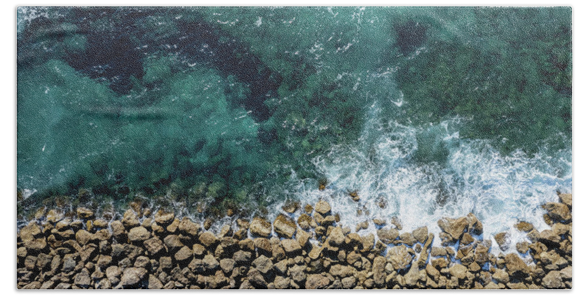 Seascape Bath Towel featuring the photograph Aerial view from flying drone of crystal blue ocean water and sea wall. by Michalakis Ppalis