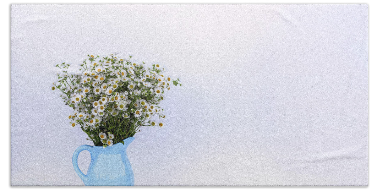 Flower Hand Towel featuring the photograph Bouquet of small white daisy flowers in a blue ceramic vase by Olga Strogonova