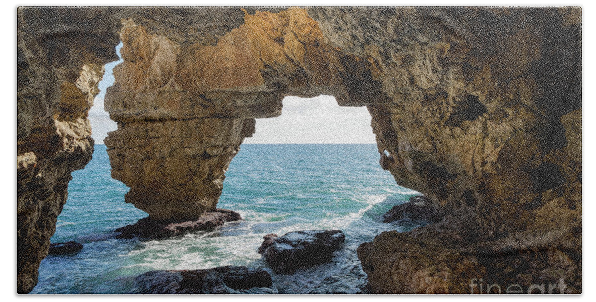 Coast Bath Towel featuring the photograph Cave on the Mediterranean coast, Cova del Arcs by Adriana Mueller