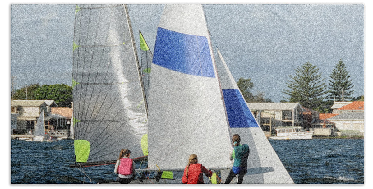 Csne63 Hand Towel featuring the photograph Children close racing small sailboats on a coastal lake. by Geoff Childs