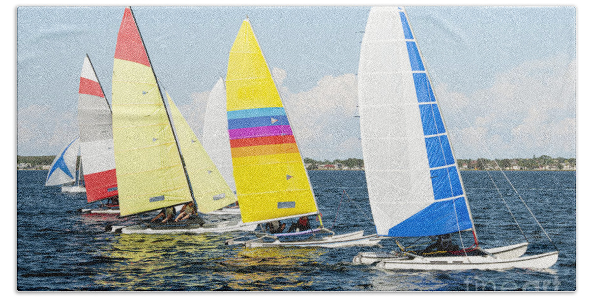 Sky Hand Towel featuring the photograph Children close sailing, racing catamarans with brightly coloured by Geoff Childs