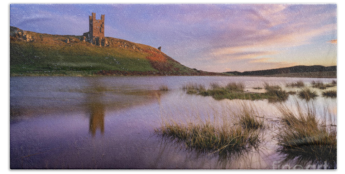 Sunset Bath Towel featuring the photograph Dunstanburgh Castle reflections at sunset Embleton Bay, Northumberland, England by Neale And Judith Clark