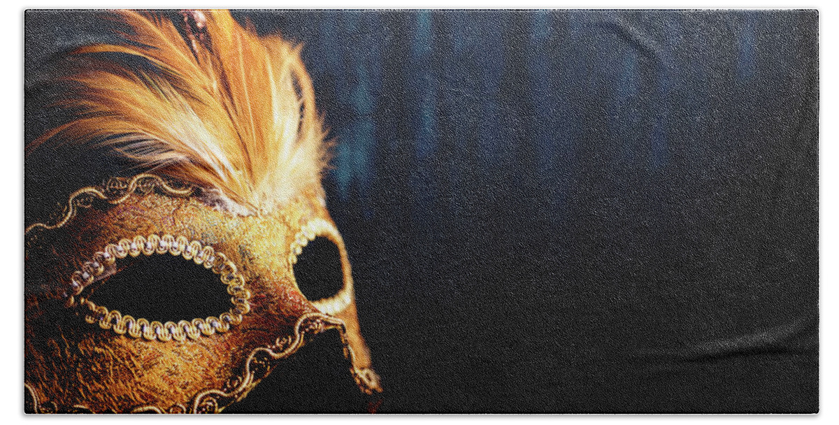 Mask Bath Towel featuring the photograph Golden Venetian mask on dark blue background by Jelena Jovanovic