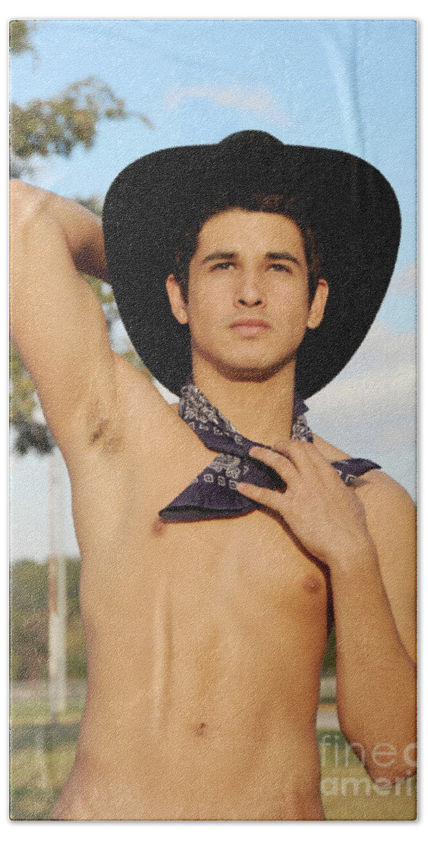 Body Hand Towel featuring the photograph Handsome hispanic cowboy is wearing a black cowboy hat by Gunther Allen