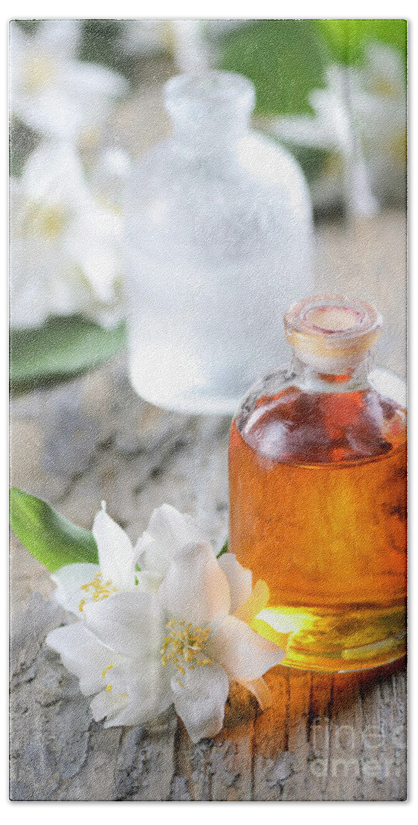 Essential Hand Towel featuring the photograph Homemade Essential oil and fresh jasmine flower by Jelena Jovanovic