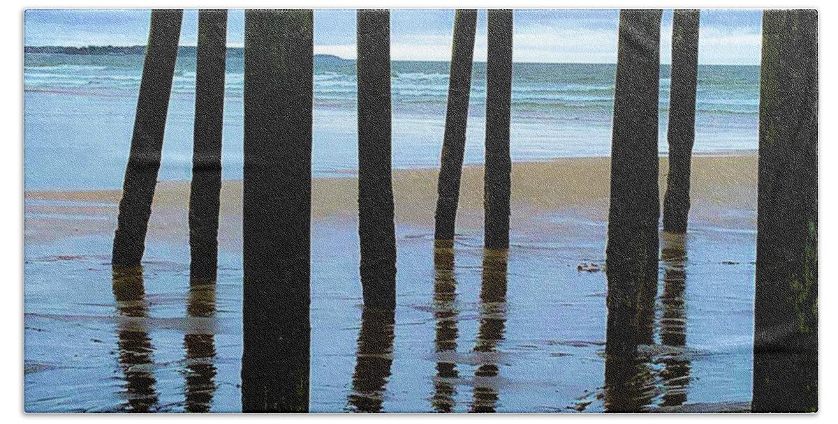 Ocean Sea Water Atlantic Beach Sand Low Tide Tidal Waves New England Maine Wood Pilings Cloud Cloudy Moody Old Orchard Beach Summer July Shadows Reflections Bath Towel featuring the photograph Low tide under the pier by Bruce Carpenter